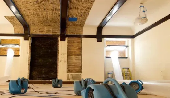 Water damage drying equipment in flooded room
